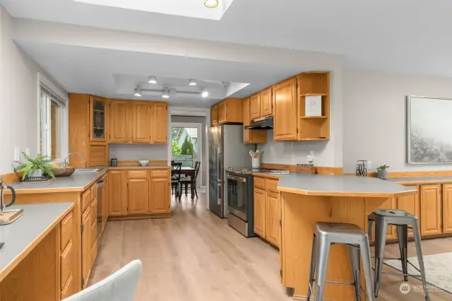 The kitchen is spacious and offers a long peninsula and loads of cabinets.