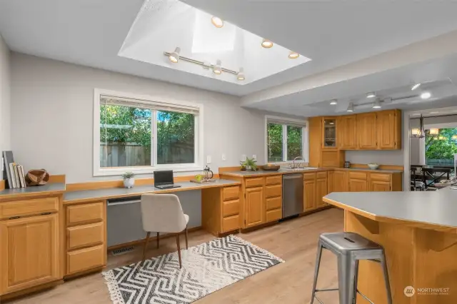 A large skylight allows added natural light to flood the kitchen. The kitchen is a gathering space for all.