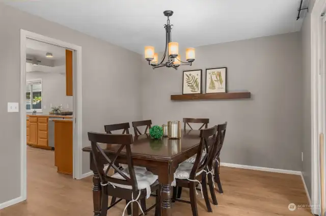 The formal dining room is well appointed. A slider on the right connects to the backyard and deck.
