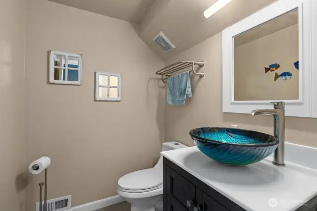 Half bath on the main floor, next to the entrance of the garage