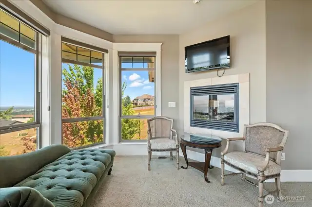 Primary suite sitting area next to your own person 2-sided fireplace and views!