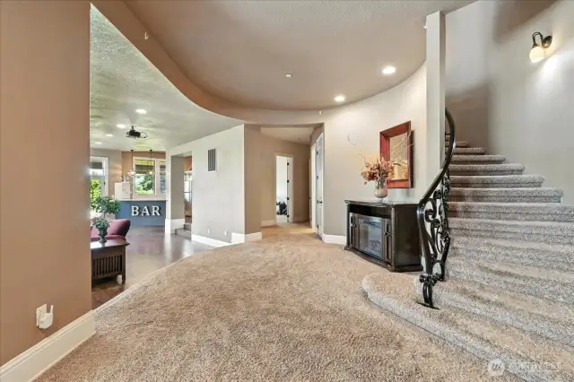 The lower floor features a large bonus room, two bedrooms, and a half kitchen/bar which is ideal for entertaining, hosting guests, or be potentially used as a separate living suite.