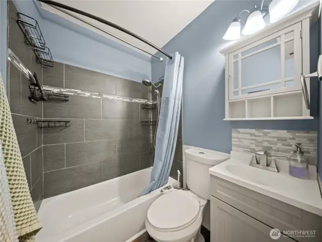 Full bath with tiled shower.