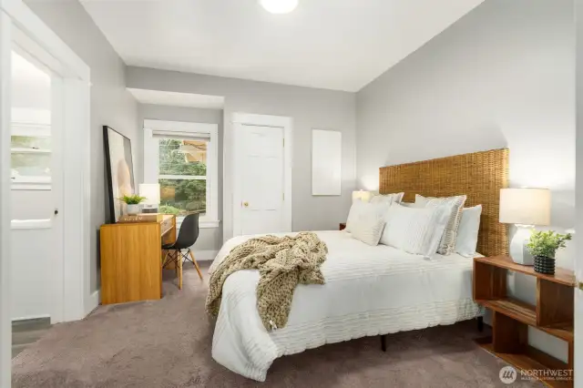 First main level bedroom with walk in closet. Closet has window for natural light.