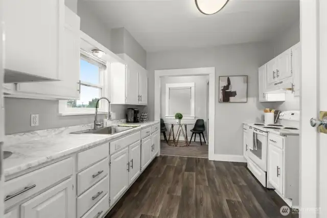 Laminate flooring. Updated hardware and sink faucet. Existing kitchen appliances stay with home. Adjacent bistro table or additional serving space.