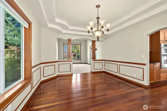 Formal dining room with chandelier, tray ceiling and chair rail trim