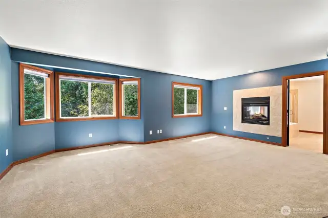 Primary suite with bay window and dual sided fireplace