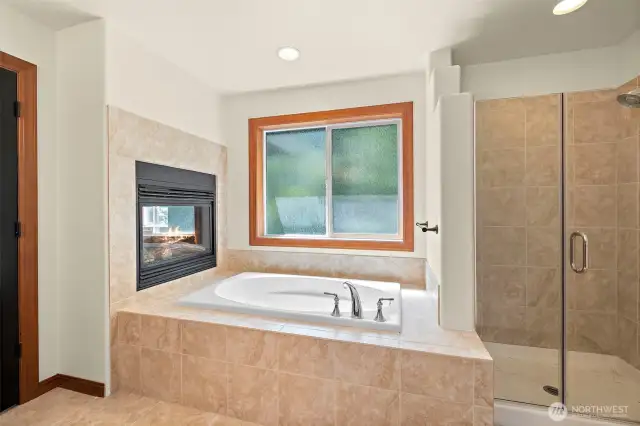 Soaking tub with dual sided fireplace
