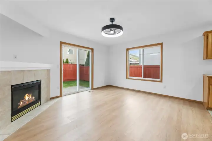 Corner gas fireplace in living room. New light fixture/fan instakked.