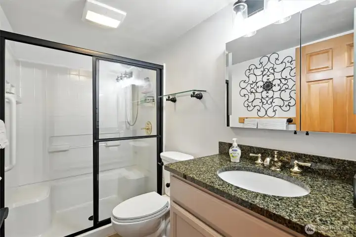 Bathroom has been updated with tile flooring with in floor heat, great shower with seat and lovely granite vanity.