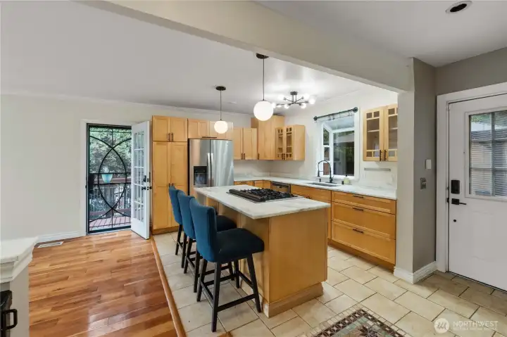 Updated maple cabinetry with stone countertops, this kitchen was designed to entertain while keeping the focus on lake views.