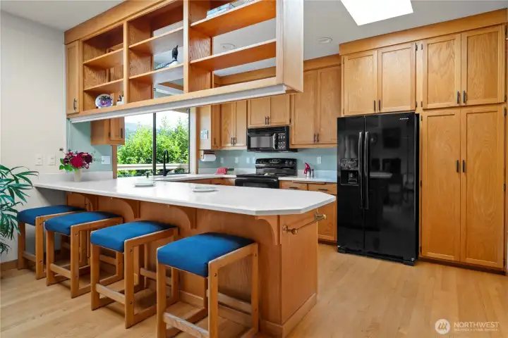 Lovely breakfast bar, and ample counterspace add to this elegant kitchen. Solid wood cabinets and solid surface countertops.