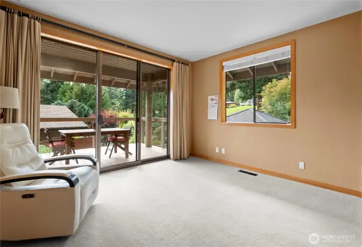 Bedroom on main floor with large glass slider (8' tall) to the newly designed deck. See virtual tour link for 3D walkthrough and interactive floor plans.