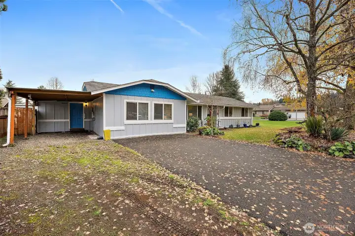 Covered carport with entrance to the attached shop to the right of house just off the driveway