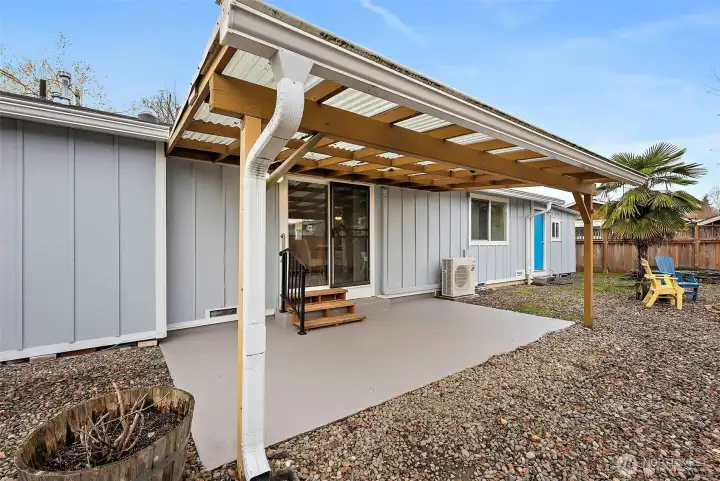 Enter the covered back patio from sliding door off living room. Attached shop also allows access to the backyard (blue door).