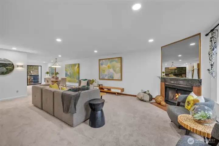 The living room lives large.  Can lighting, big picture window lots tons of light in and the wood burning fireplace ties the space together.