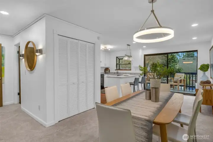 The dining room is central to the living room and kitchen. Closet can be used for coats and other items. There is a powder room left of the mirror that makes it convenient for you and your guests.