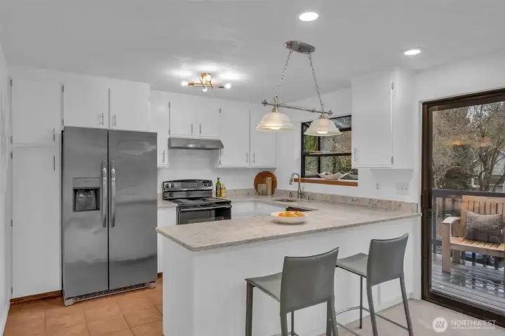 Updated kitchen with newer appliances, quartz counter, new lighting and subway tile.  Garden window to grow your fresh herbs and let tons of light into the kitchen. Tons of cabinet and counterspace.  A great gathering space.