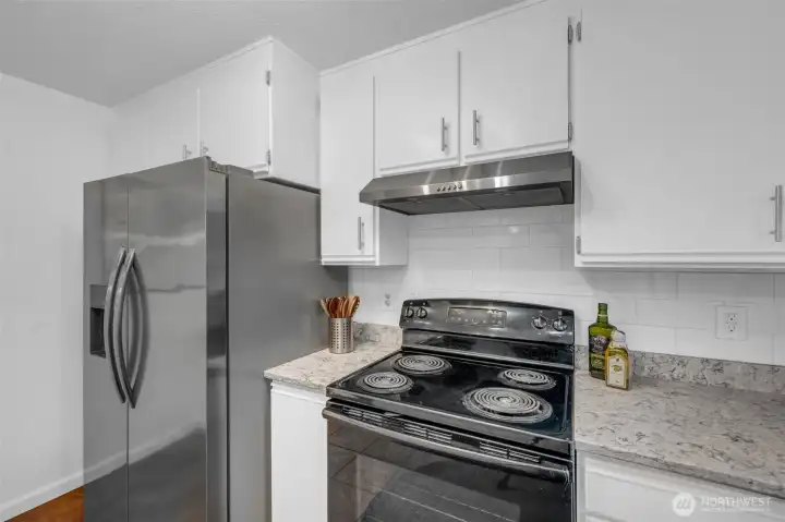 Newer side by side refrigerator freezer with ice and water dispenser.