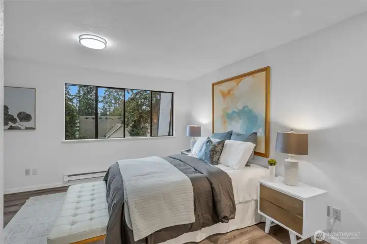 The primary bedroom faces west and get lots of natural light. Luxury vinyl plank flooring, new base molding and lighting.  Attached three quarter bath with walk in shower.