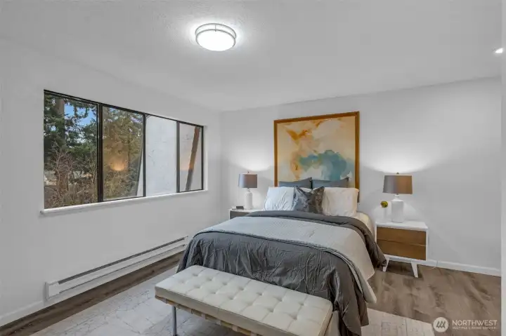 The primary bedroom faces west and get lots of natural light. Luxury vinyl plank flooring, new base molding and lighting.  Attached three quarter bath with walk in shower.