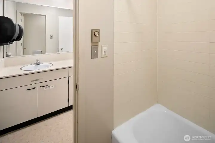 A full bath is part of this office area suite