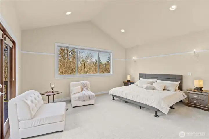 Primary suite with vaulted ceilings, ensuite 5 piece bath and walk in closet