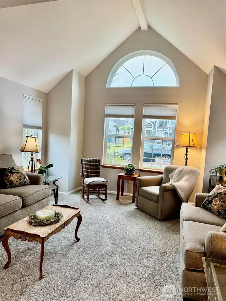 Living room is light and bright with vaulted ceilings, newer carpet and blinds!