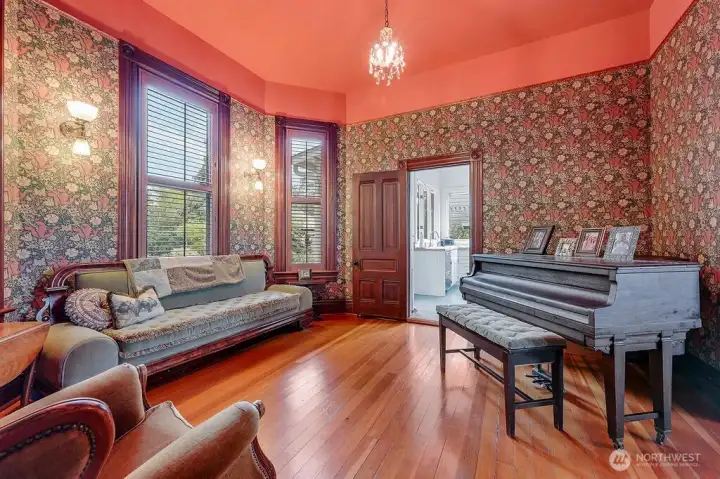 A traditional parlor centered around a piano that remains, having its own  history.