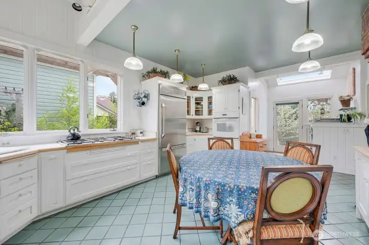 Kitchen with casual eating area. Updated propane stove and appliances. Doorway exits to sideyard.