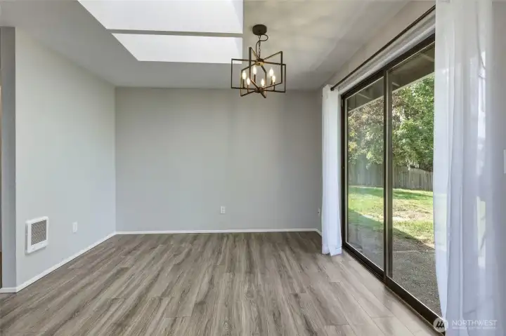 Dining area adjacent to kitchen, with view of the spacious back yard!