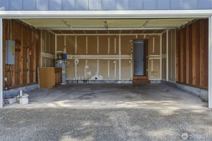 Spacious garage ... door opens to utility room, which leads to interior.
