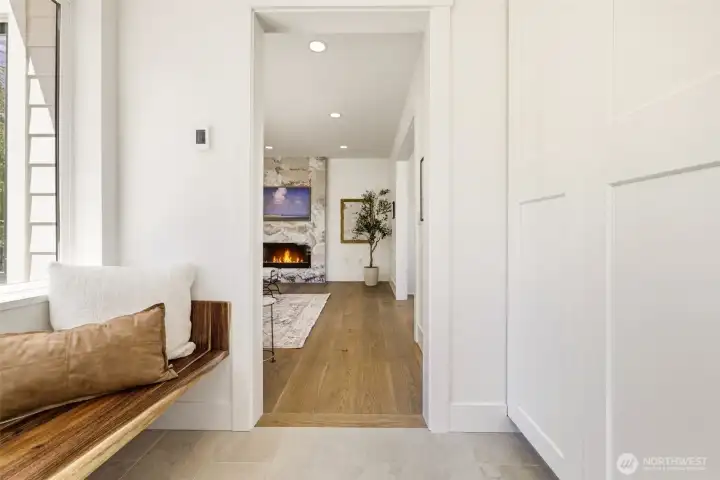 custrom entryway with floating bench, heated floors, and built-in closet