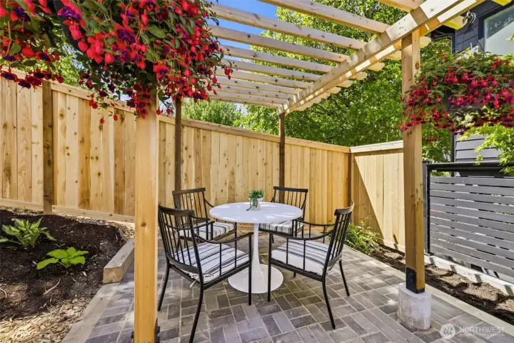 back door leads to patio and side yard with afternoon sun