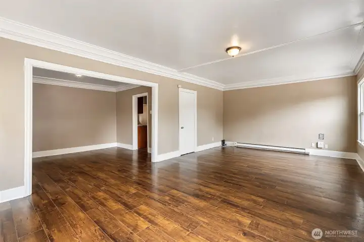 Open living room with flexible layout and original crown moulding. Open living room with flexible layout and original crown moulding.