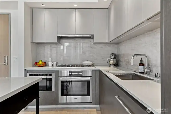 Beautiful Bosch appliances, quartz countertops, and marble back splash.