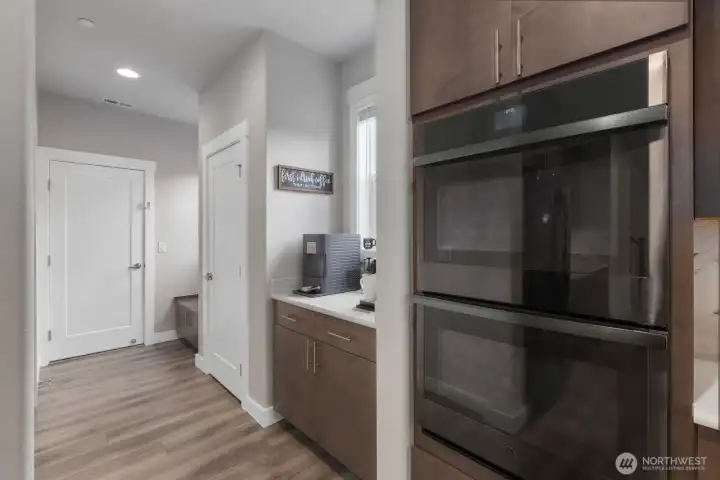 Double ovens, coffee bar, mudroom, and door to garage