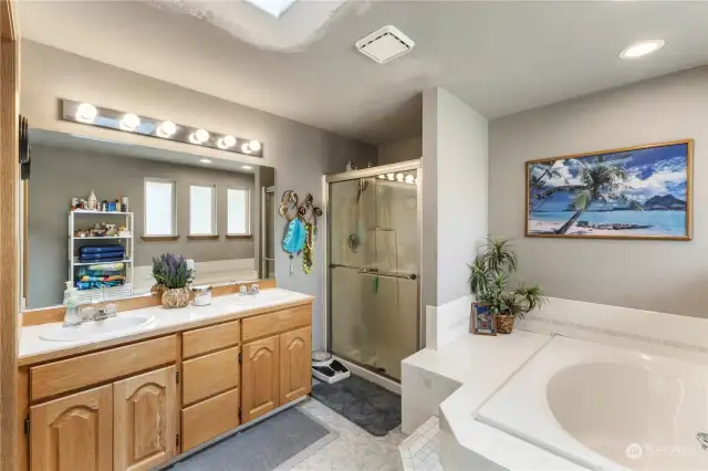 Primary bathroom with soaking tub, separate shower & double sink vanity.