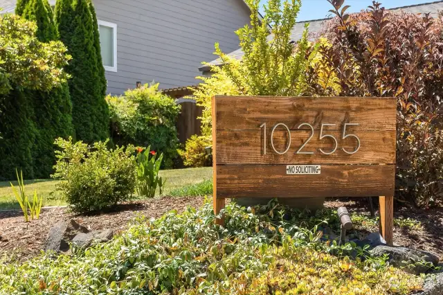 Beautiful house number prominently installed at the front of the landscaping