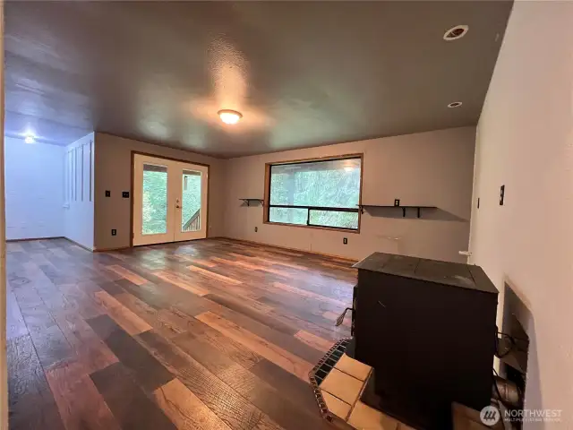 Lower level great room with wood stove and French doors