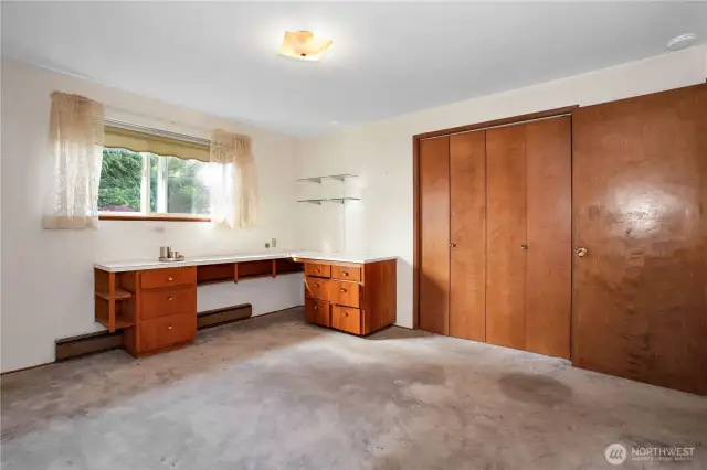 This large size bedroom has a desk built in yet there is room for a king or queen bed.