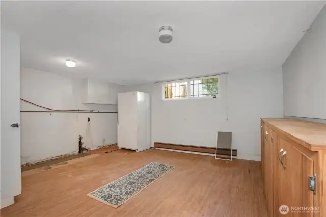 The laundry room is oversized and can serve as storage and more in addition to doing the laundry. Fridge conveys with home.
