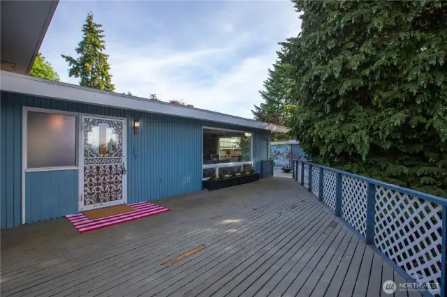 The deck that leads up to the front entrance has a peak-a-boo view of the water that improves when the trees are bare.