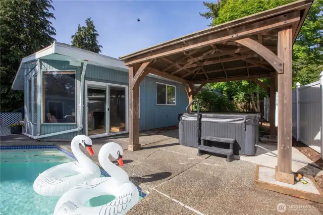 Step out from the sun room to the back yard. The gazebo shelters you when you want a dip in the hot tub during liquid sunshine.