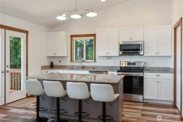 Granite countertops, a huge island, and a walk-in pantry (not shown) makes this kitchen a delight to cook in.