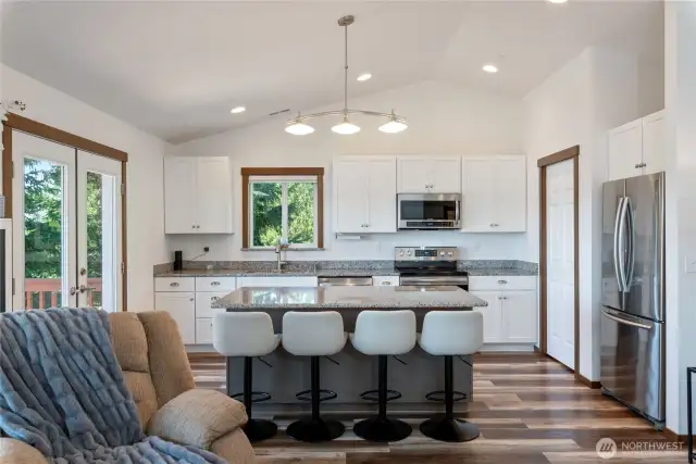 We love the layout here, with the great room concept. The living room and kitchen and eating areas blend seamlessly together.