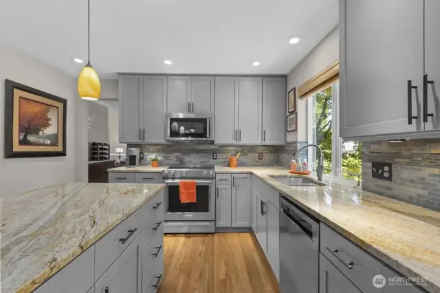 With sleek granite countertops, a stylish tile backsplash, and thoughtful lighting, this kitchen blends modern function with designer flair.