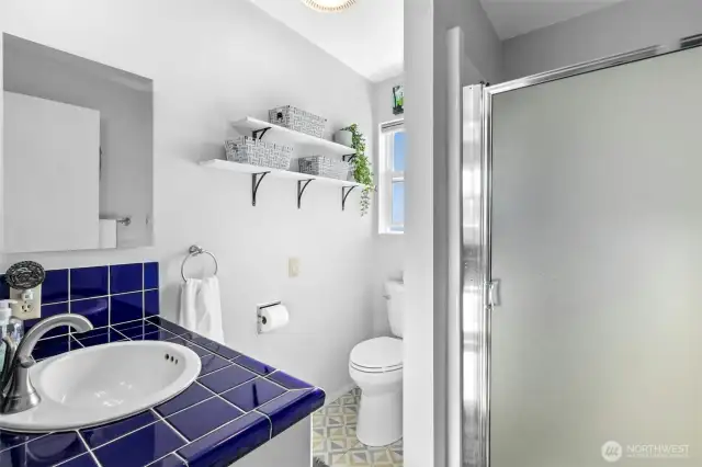 3/4 bath within the ensuite. Nautical colors, crisp and clean.