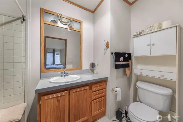 The en-suite bathroom includes an oak vanity, ample lighting, and generous counter space—designed with ease and functionality in mind for 55+ living. Tucked inside Lake Samish Terrace, it’s part of a home designed for low-maintenance comfort.