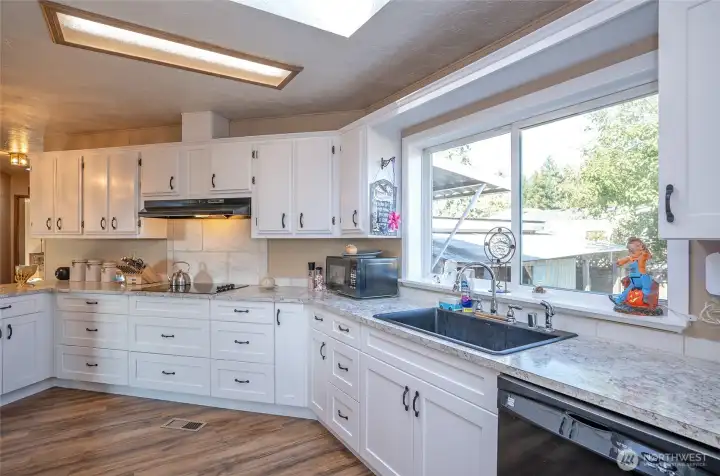 Expansive window invites sunlight to pour in, brightening the space.